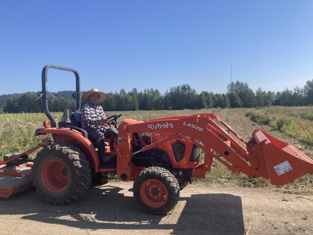 Hmong farmer on a tractor